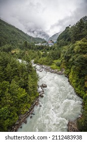 A beautiful landscape with a stormy mountain river in the Himalayas (Alps) in Nepal on the way of trekking to Everest in the Sagarmatha National Park. Cloudy weather, vertical image