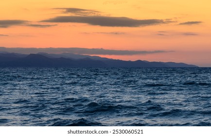 Beautiful landscape with a stunning sunset. Rocky coastline and mountains. Taken from above from the sea. Cyprus - Powered by Shutterstock