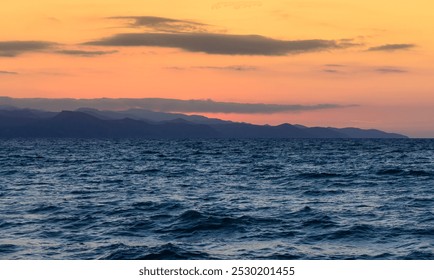 Beautiful landscape with a stunning sunset. Rocky coastline and mountains. Taken from above from the sea. Cyprus - Powered by Shutterstock