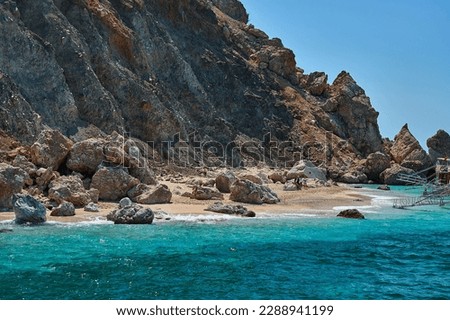Beautiful landscape of Suluada with its turquoise waters, boats and people swimming. Taken during yacht boat tour from Adrasan, Antalya, Turkey, Mediterranean Sea