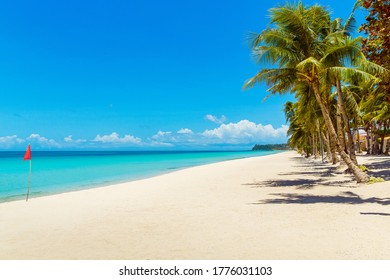 Beautiful landscape of tropical beach on Boracay island, Philippines under lockdoun. Coconut palm trees, sea, sailboat and white sand. Nature view. Summer vacation concept. - Shutterstock ID 1776031103