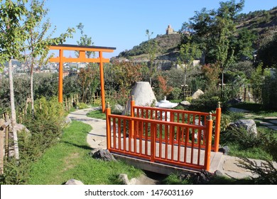 Beautiful landscape with vermilion torii gate and bridge fence in Japanese Garden, Tbilisi botanical garden, Tbilisi, Georgia