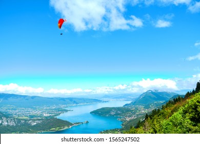 Beautiful landscape view of Annecy Lake from Col de la Forclaz the place for skydiver sport in sunny day with view blue ocean lake, mountain, forest, white cloud and blue sky.