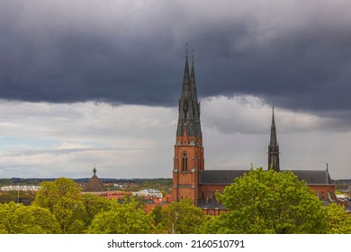Beautiful landscape view of top towers of Uppsala Cathedral Church on thunderclouds sky. Sweden. 