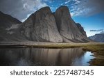 Beautiful landscape of Water front view of mountains on Akshayuk Pass, Buffin Island, Canada. Pond reflections