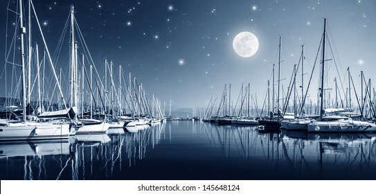 Beautiful landscape of yacht harbor at night, full moon, marina in bright moonlight, luxury water transport in nighttime, vacation concept  - Powered by Shutterstock