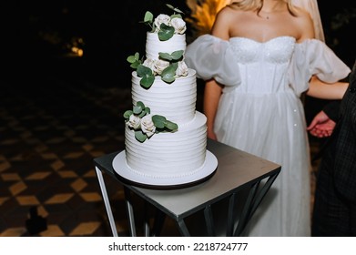 A Beautiful, Large, Three-tiered Cake Is On The Table At A Party At Night. Wedding Food Photography.