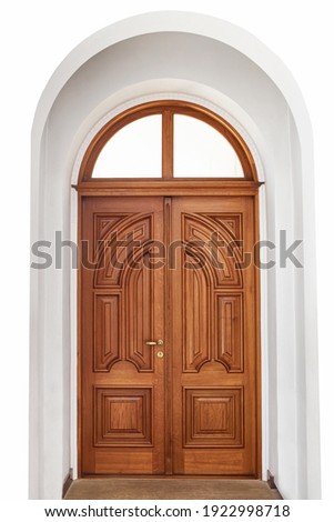 Beautiful large wooden door on a white background wall. Hand carved, vertical pattern