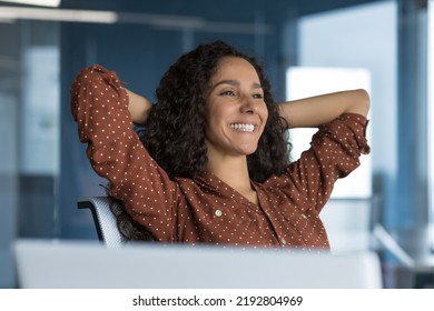 Beautiful Latin American Business Woman Resting In The Office, Businesswoman With Her Hands Behind Her Head, Satisfied With The Work Result, Using A Laptop, Close-up Photo