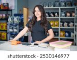 beautiful latin american saleswoman entrepreneur at the counter in an auto parts supply store	