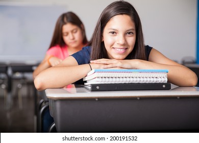 Beautiful Latin high school student enjoying class and smiling