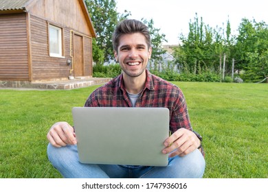 Beautiful latin young men with a laptop working outside on the grass with a big smile - Shutterstock ID 1747936016