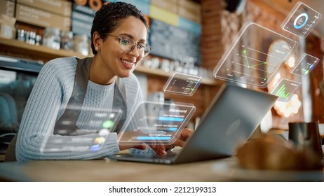 Beautiful Latina Coffee Shop Owner is Working on Laptop Computer and Checking Inventory in a Cozy Cafe. Restaurant Manager Browsing Internet and Chatting with Friends. VFX Augmented Reality Concept. - Shutterstock ID 2212199313