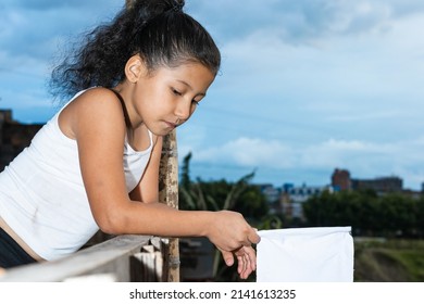 Beautiful Latina Girl, Very Sad Brunette With A White Flag In Her Hand (peace Flag) Thinking About Her Freedom. Girl Bored By So Much Violence In Her Country. Concept Of Freedom.