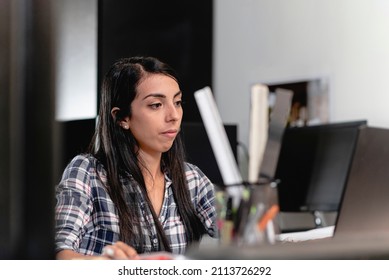 Beautiful Latina Woman In Her Office Using Her Computer On Her Desk	