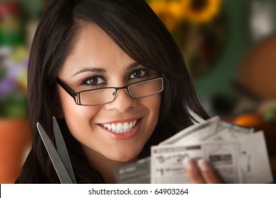 Beautiful Latina Woman At Table In Kitchen With Coupons