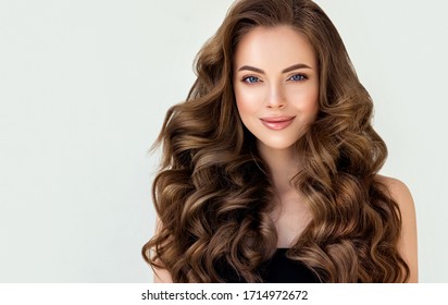 Beautiful laughing brunette model  girl  with long curly  hair . Smiling  woman hairstyle wavy curls . Red  nails manicure .    Fashion , beauty and makeup portrait
 - Shutterstock ID 1714972672