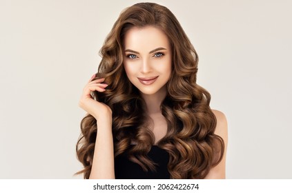 Beautiful laughing brunette model  girl  with long curly  hair . Smiling  woman hairstyle wavy curls . Red  nails manicure .    Fashion , beauty and makeup portrait
 - Shutterstock ID 2062422674