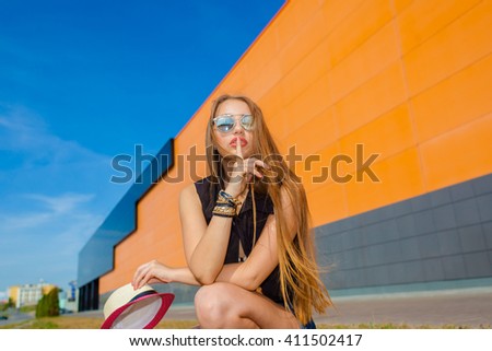 Beautiful laughing girl . Free woman enjoying freedom feeling happy. Hipster girl showing happy positive emotions on the background of the shopping center