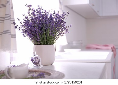 Beautiful Lavender Flowers On Countertop In Kitchen. Space For Text