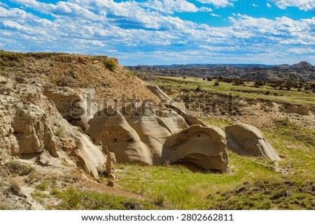 Beautiful Layered Eroded Rock Formations at the Terry Badlands in Eastern Montana.

This Wilderness Study Area is located near the small town of Terry in Eastern Montana.  The town is named after Alfred Howe Terry, a general in the Union army who commanded an expedition with George Armstrong Custer against the Native Americans in the West.

This area is a mix of beautiful multi-colored badlands standing above rolling prairies.  There are amazing rock formations including natural bridges, spires, toadstools. mushrooms and buttes.  In the spring, the badlands and gullies have lush green grasses and shrubs with brightly colored wildflowers and cactuses.  The area is also a home to a diverse variety of wildlife.  Petrified logs can also be found in this wilderness area.