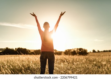 It's a beautiful life. Happy woman lifting her arms up to the sunlight.  - Shutterstock ID 2206799421
