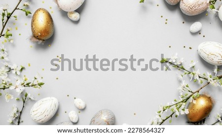 beautiful light easter layout with marble eggs, cherry blossoms and confetti on a white background. top view. copy space. flat lay. place for text