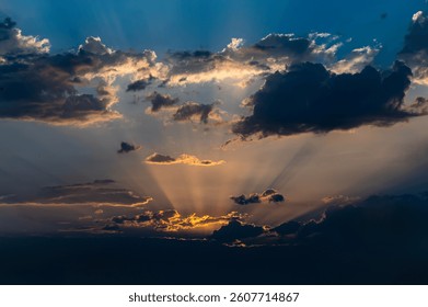 beautiful light rays through the clouds in the sunset sky 
