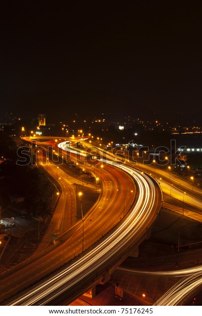 beautiful light trail at\
the busy highway