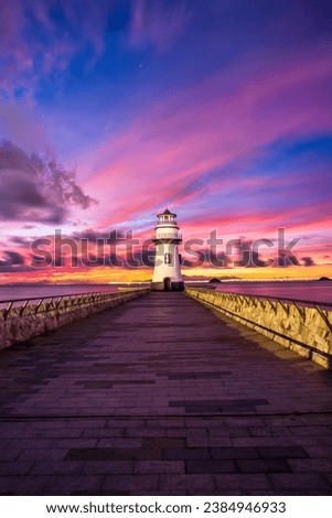 Beautiful lighthouse scenery at sunrise by the sea, Zhuhai, Guangdong Province, China.