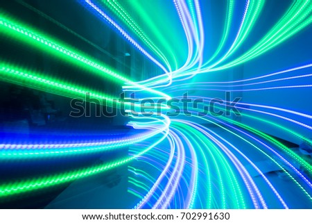 The beautiful lighting of path when there is movement of the origin of multi colored lights. Slow shooting style and light color blur Applied as a backdrop.