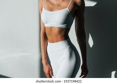 Beautiful lighting. Young caucasian woman with slim body shape is indoors at daytime. - Shutterstock ID 1937198422