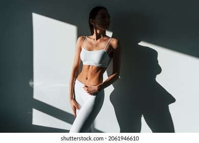 Beautiful lighting. Young caucasian woman with slim body shape is indoors at daytime. - Shutterstock ID 2061946610