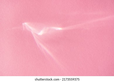 Beautiful Lights And Shadows Of Glass On Pink Background. Overlay Mode. Caustic Effect Of Light. Sun Hard Reflection. Shadows Texture. Blurred Water Backdrop. Top View. Trendy Concept