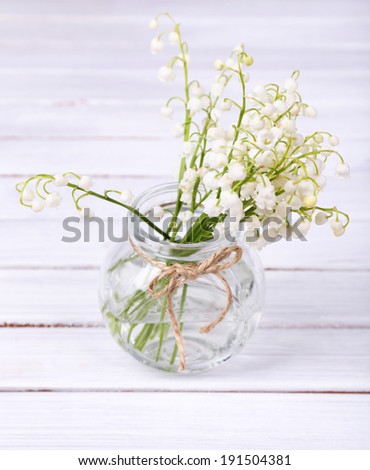 Cherry blossom branch with butterfly ornaments in glass jar