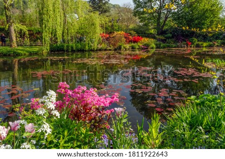 Beautiful lily pond in spring in Claude Monet's garden, flowers and plants reflected in the water. Giverny, France.	