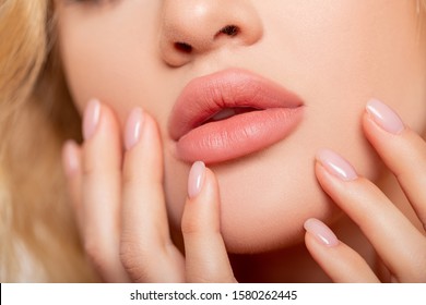 Beautiful lips Close-up. Makeup. Lip matte lipstick. Sexy lips. Part of face, young woman close up. advertisement. perfect plump lips bodily lipstick. peach color of lipstick on large lips.       