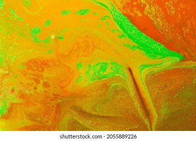 Beautiful liquid texture the nail polish Orange green yellow colors Background and copy space Fluid art pour painting technique Good as digital decor 