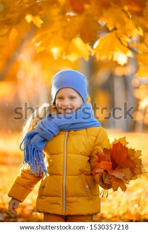 Similar – Herbstportrait eines lächelnden Kindmädchens mit Blumenstrauß aus Blättern