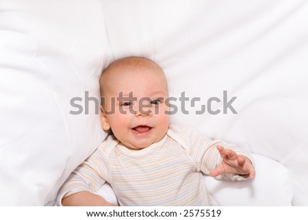 Similar – Der kleine Junge lächelt im Bett in seinem eigenen Zimmer.