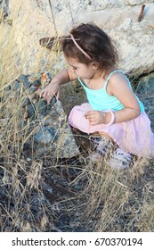Beautiful little brunnette girl playing amongst ruins