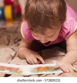 beautiful little child girl learns to read (success, education, childhood, development) - Shutterstock ID 572809231