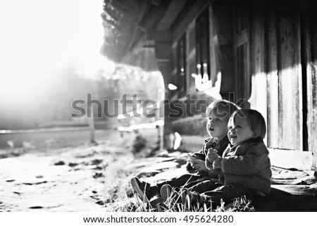 Mother with her seven year old daughter laughing in a cabin in the countryside.