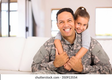 beautiful little daughter and military father at home