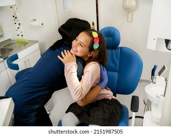 Beautiful Little Girl With Big Smile On Her Face Hugging Her Dentist After Treatment 