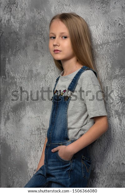 little girl in overalls