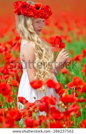 Beautiful little girl in a field of flowers
