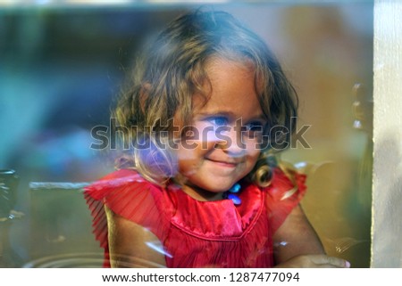 Similar – Funny child looking at the camera and painting