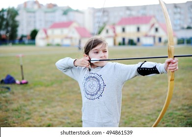 Beautiful Little Girl Shoots Bow With Archery On Training In Sport School