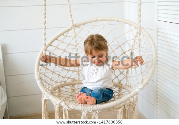 Beautiful Little Girl Swinging Hanging Chair Stock Photo